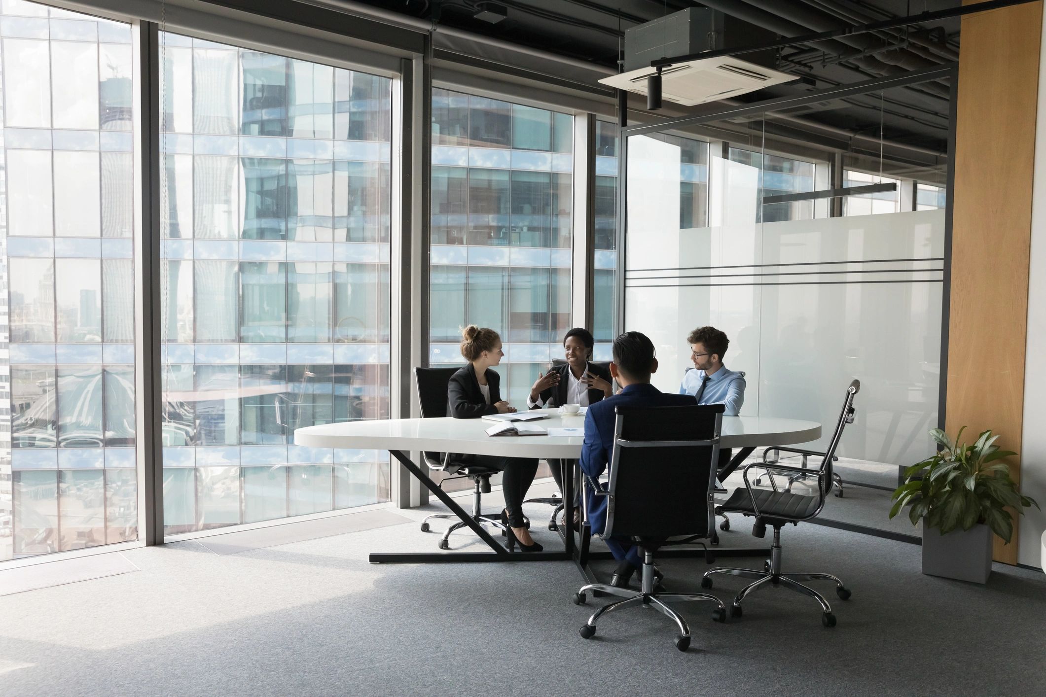 News team discussing ideas in a modern meeting room