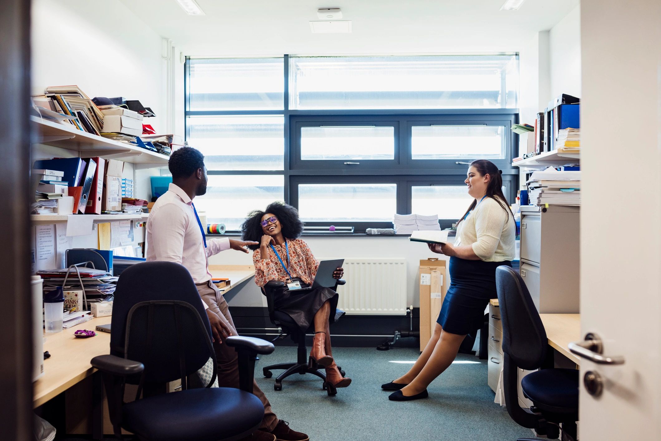 Team members in an office discussing work together